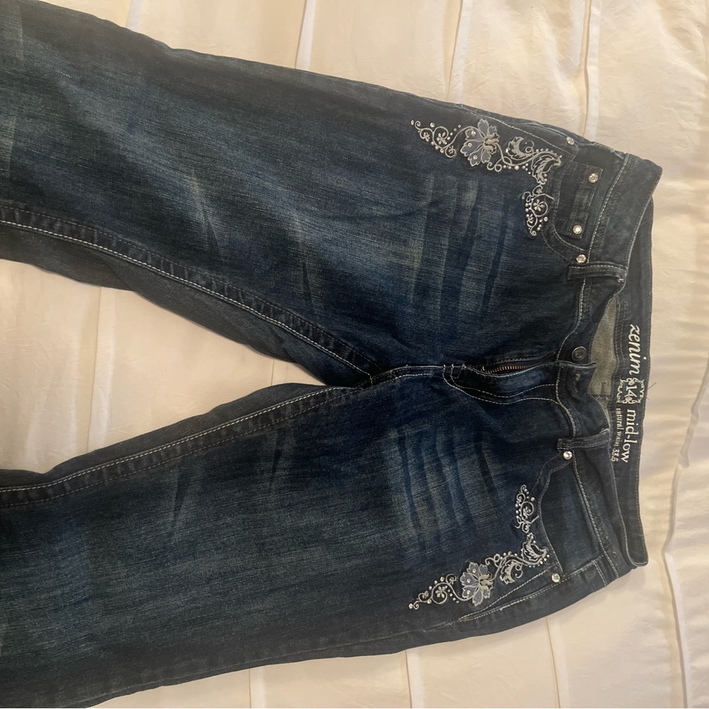 Embroidered Zenim brand mid rise jeans with crystal and stud detailing.